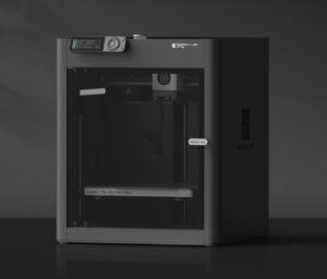 a picture of the bambu lab p1s 3d printer. it is black in color and sitting on a surface.